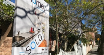 House sold sign outside a row of terraces in the inner-Sydney suburb of Glebe