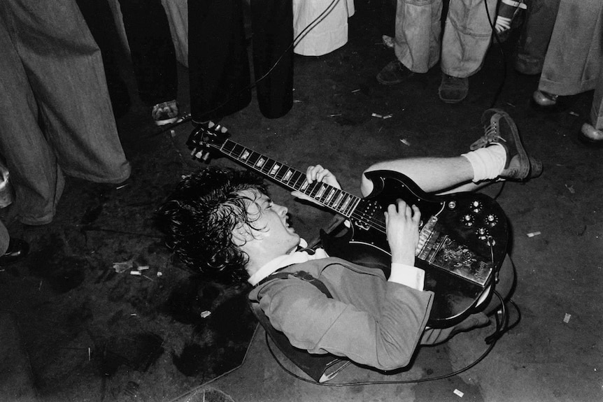 Angus Young performs Baby Please Don't Go on the floor of the Hard Rock café in Melbourne.