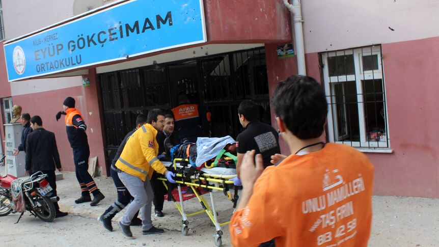 Emergency workers evacuate an injured man in Kilis
