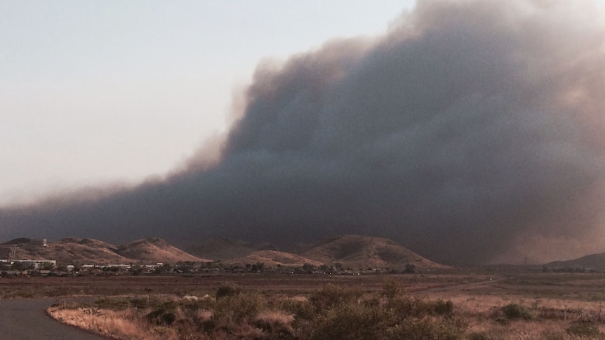 The town of Wickham has a thick black cloud of smoke behind it