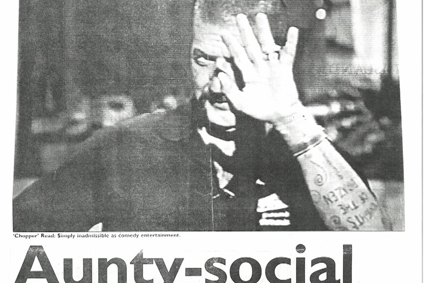 Newspaper clipping of Chopper with his hand up, headline says 'Aunty-social'.