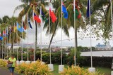 A row of flags of the members of the Pacific Islands Forum, flying outside the venue where it's taking place.