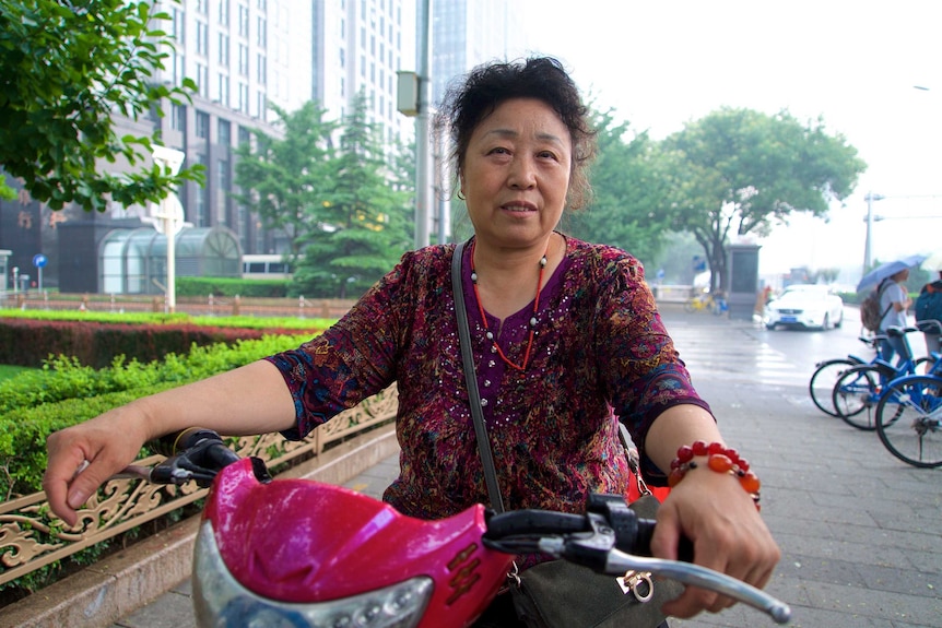 Li Xuejun rides her motorcycle through the streets of Beijing
