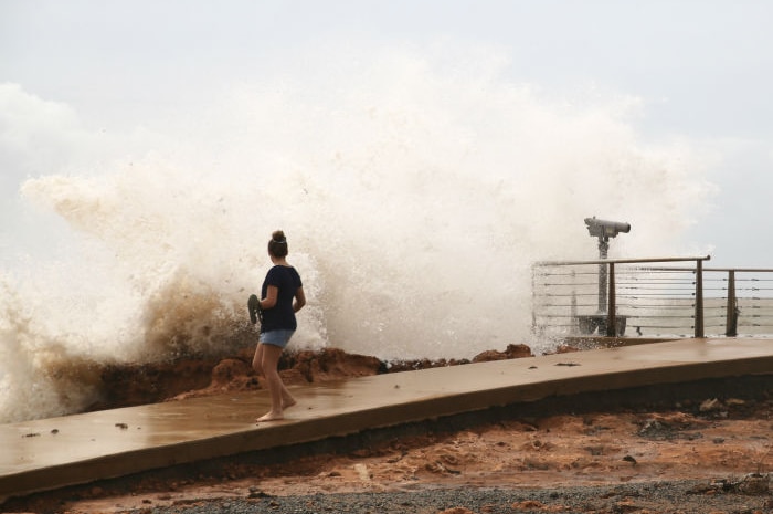 A large wave crashing over a foreshore.