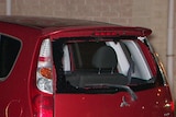 A hatchback with a smashed rear window.