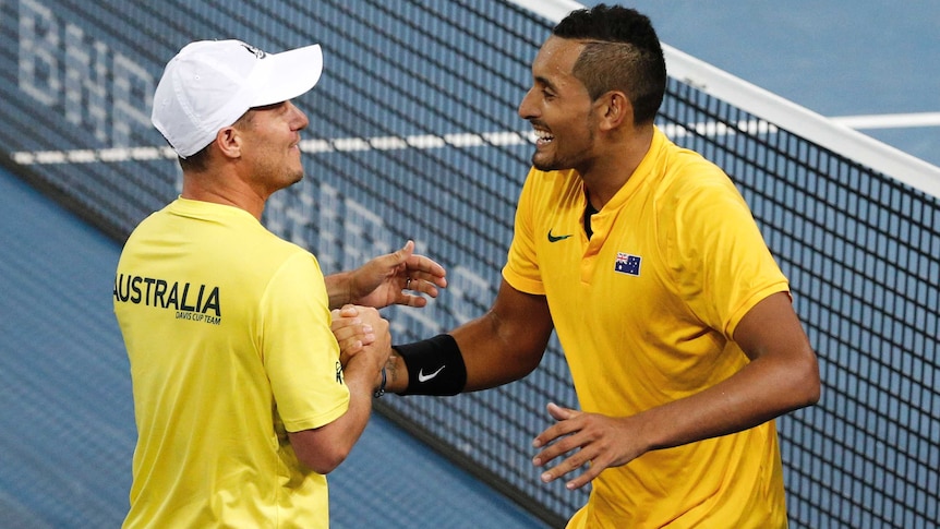 Australia's Nick Kyrgios celebrates with Australian Davis Cup coach Lleyton Hewitt.