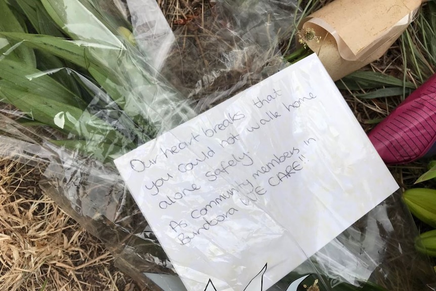 A card reads 'Our heart breaks that you could not walk home alone safely. As community members in Bundoora we care!'