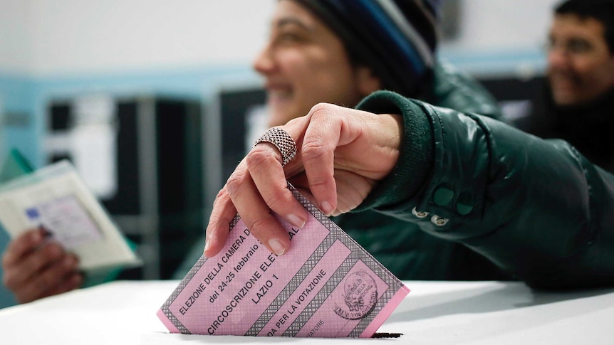 A woman votes in Rome.