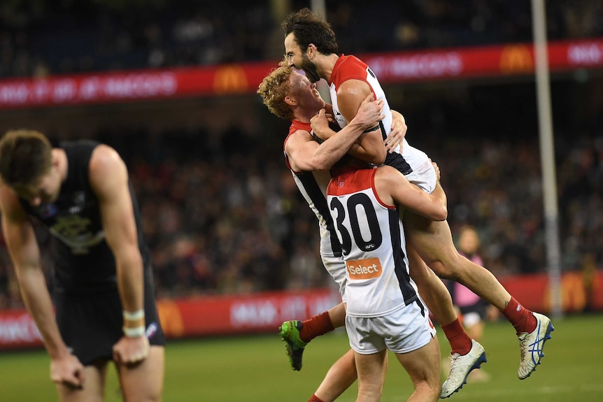 Demons players react after Jordan Lewis (R) kicked a goal against Carlton at MCG on July 9, 2017.