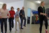 People dancing in a line in a class