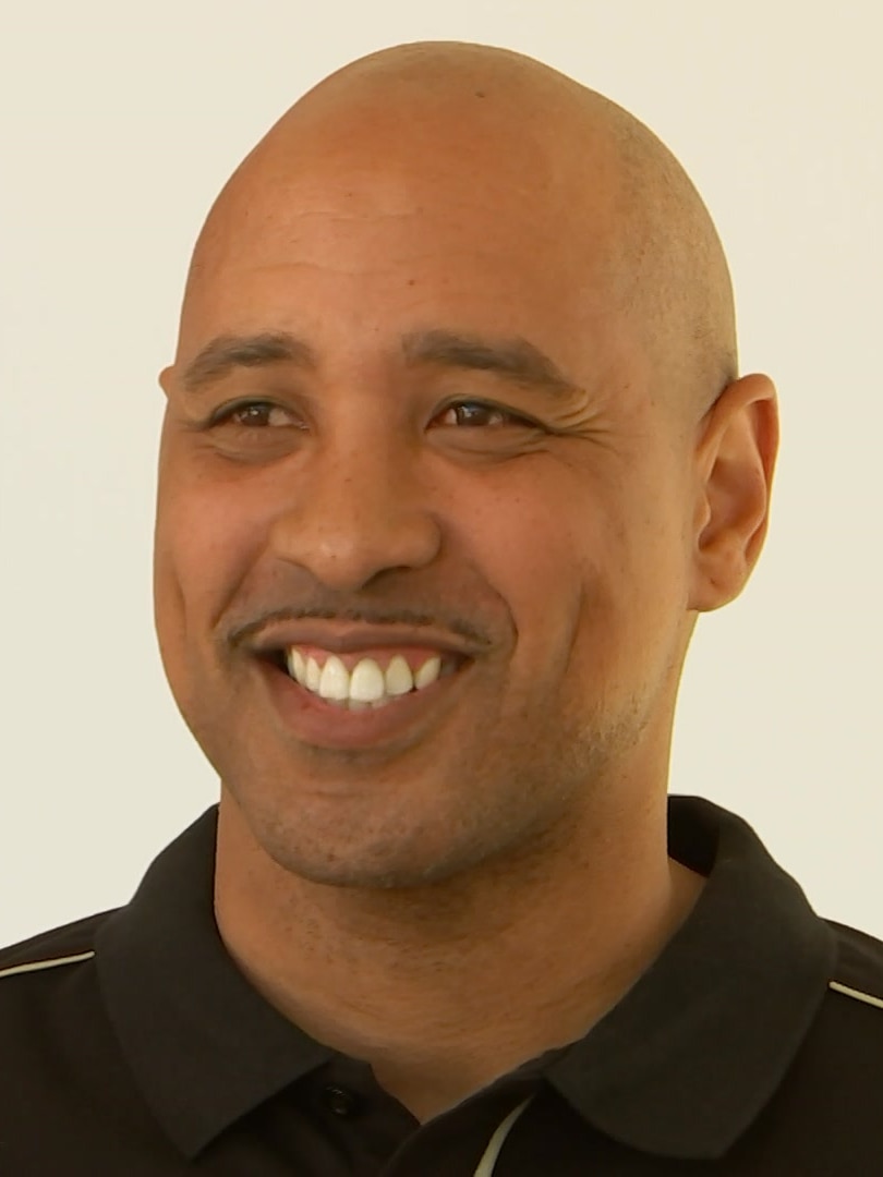 A bald man wearing a black shirt