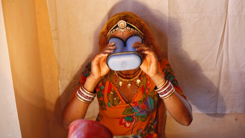 A villager goes through the process of eye scanning.