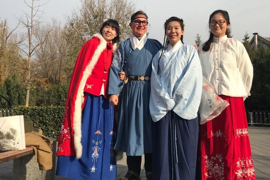 Chris Buckley dressed in traditional Chinese garb with three women
