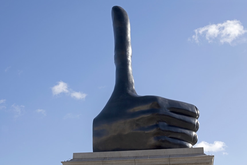 A bronze sculpture of a giant thumbs up