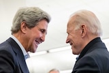 John Kerry and Joe Biden shake hands.