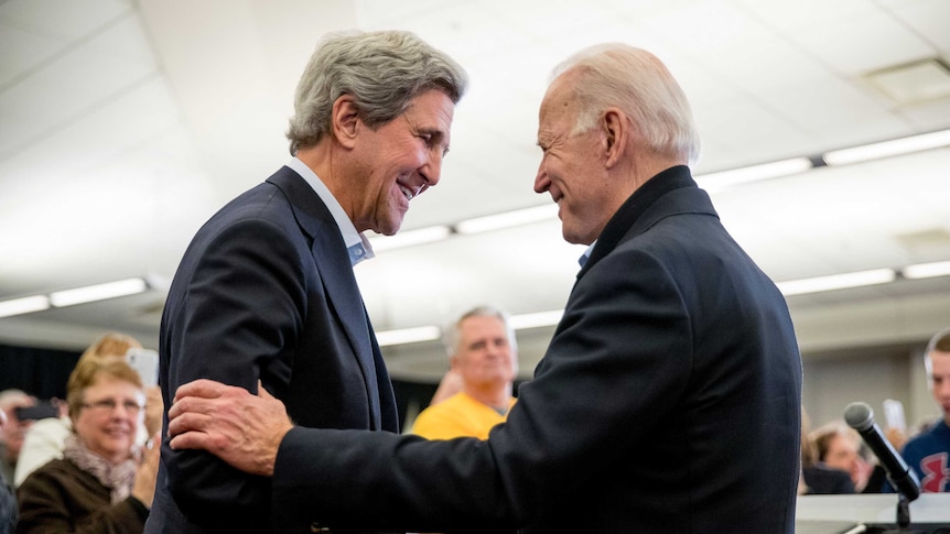 John Kerry and Joe Biden shake hands.