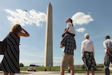 A chopper surveys the Washington Monument for damage after the quake.