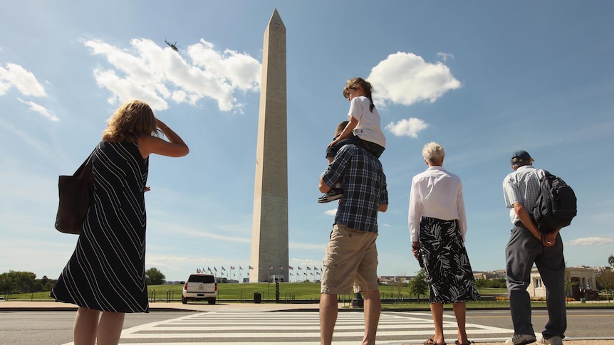 A chopper surveys the Washington Monument for damage after the quake.