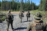 A crew of four police search remote Canadian bushland for fugitives.