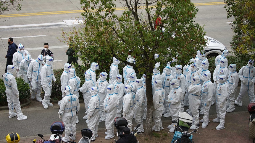 Workers in protective suits prepare for administering coronavirus tests at Shanghai Airport