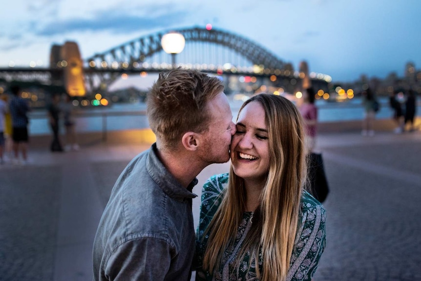 couple holding hands and dancing at Sydney harbour