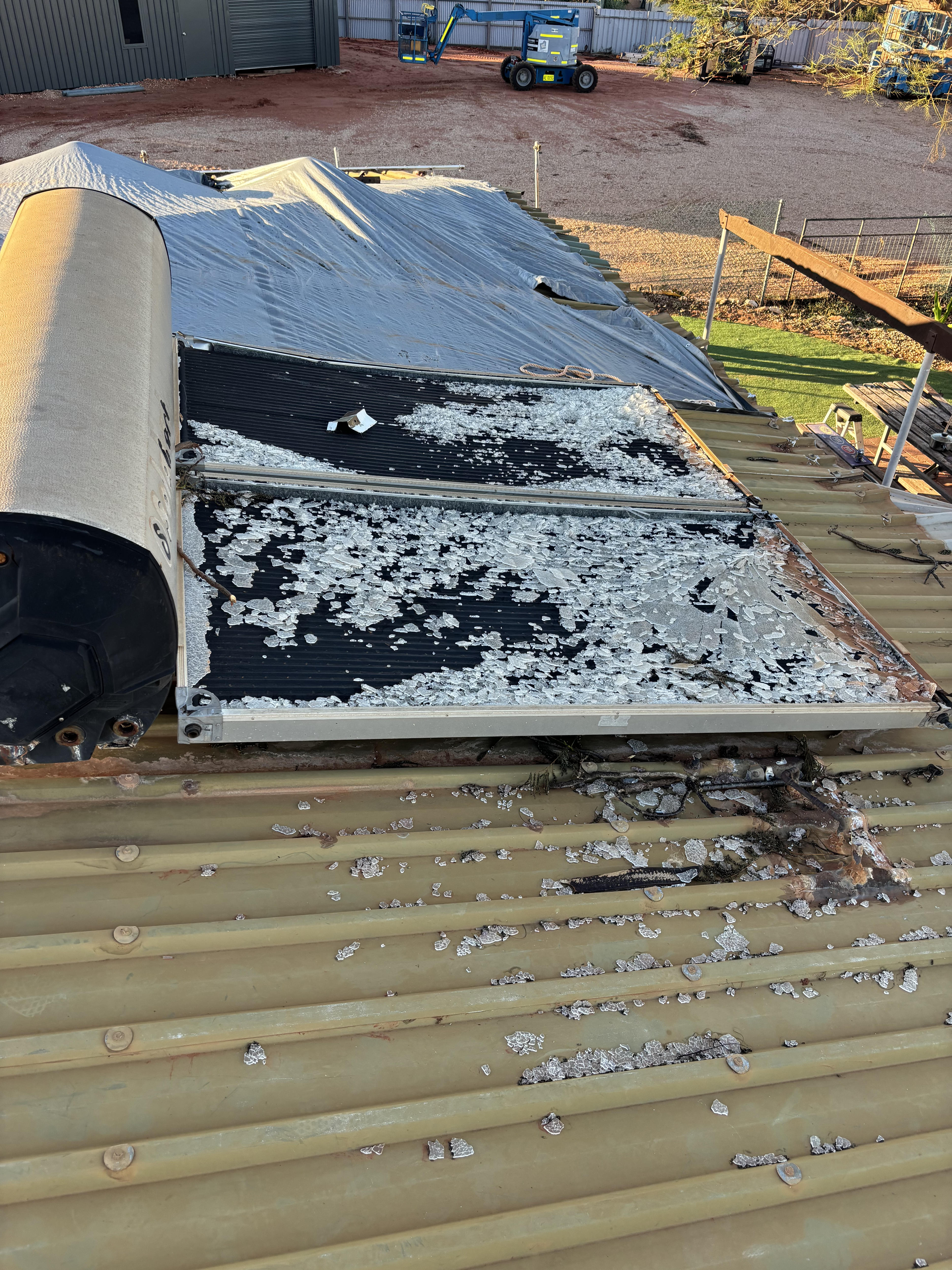 Shattered glass pieces on the roof of a house.