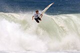 Surfer flies off a huge wave at the junior surf champs in Sydney