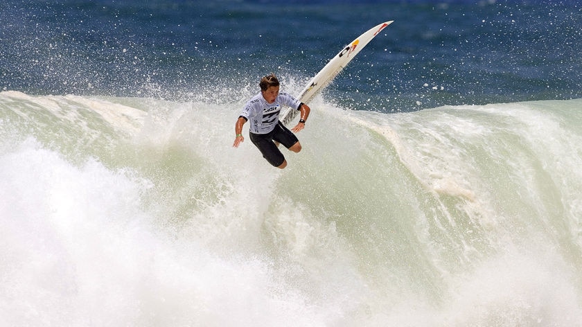 Surfer flies off a huge wave at the junior surf champs in Sydney