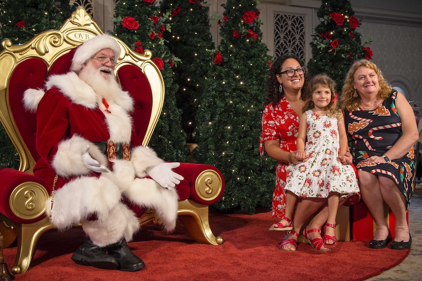 santa and a family in a photograph maintaining physical distance