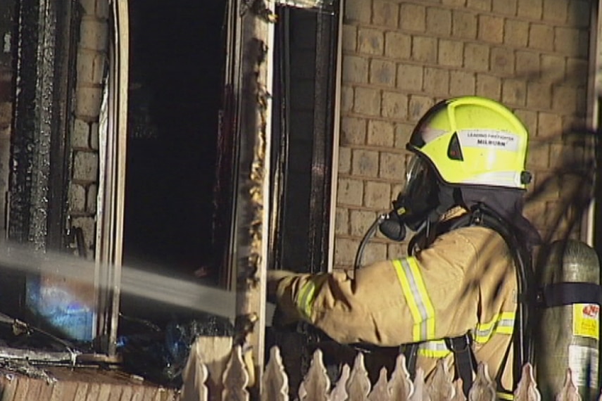 A fire fighter battles a blaze in a home in Kings Park, in Melbourne's west.