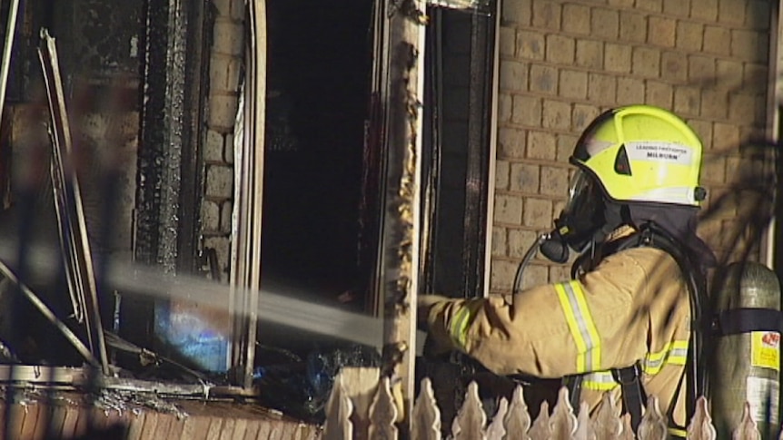 A fire fighter battles a blaze in a home in Kings Park, in Melbourne's west.