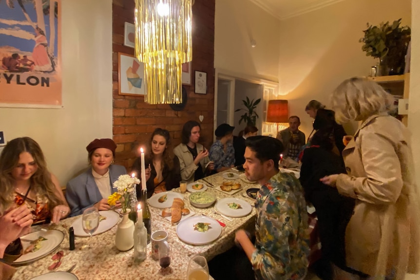 A group of friends sitting at a dining table having a meal.