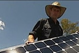 A man installs a solar panel