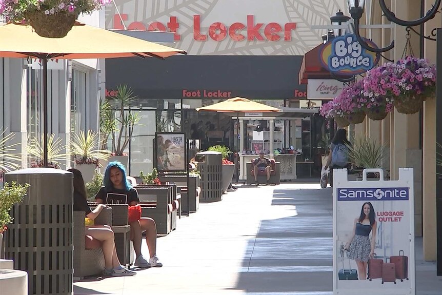 Outdoor shopping mall looks sparse with customers
