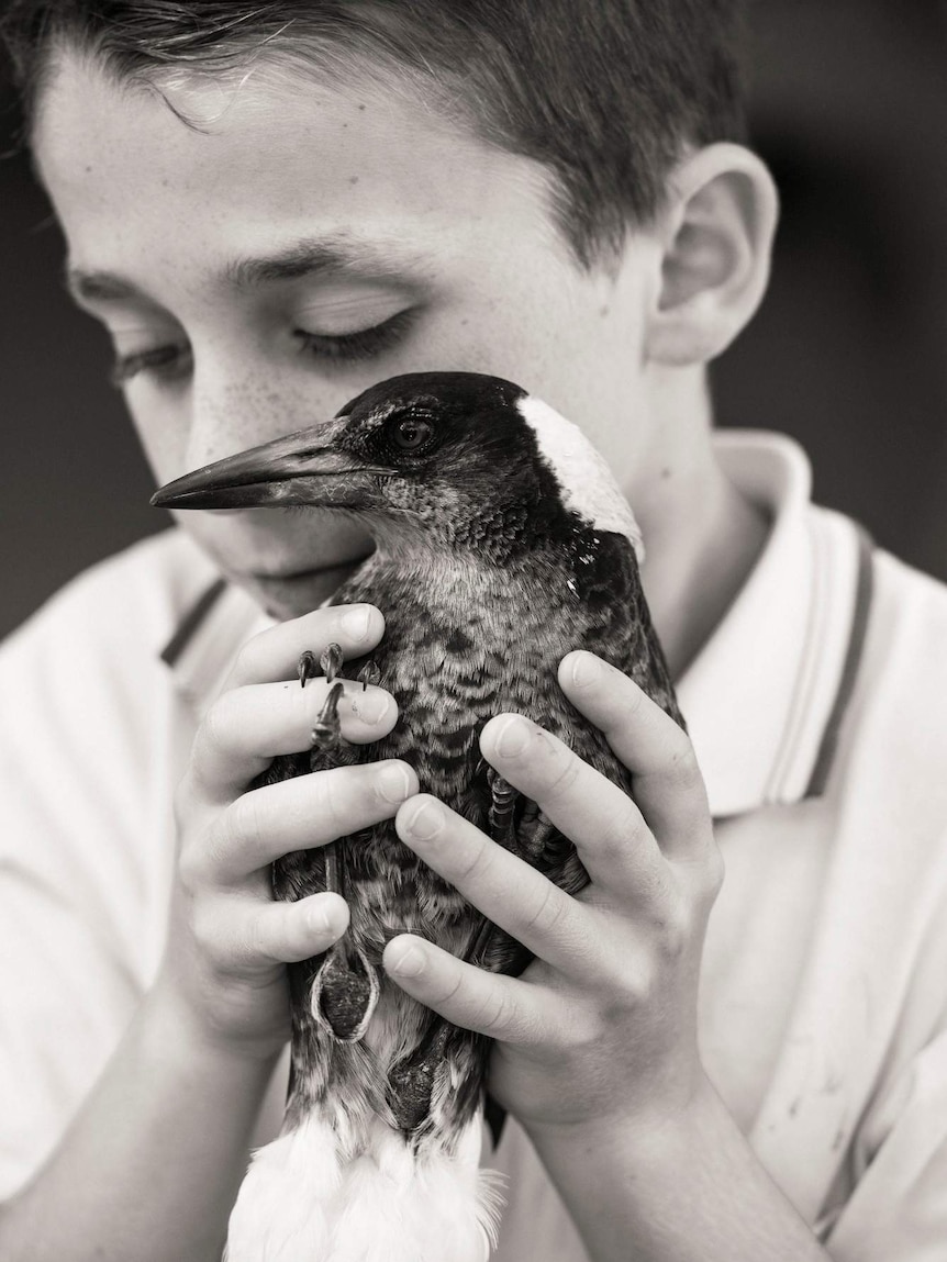 Noah Bloom with Penguin the magpie