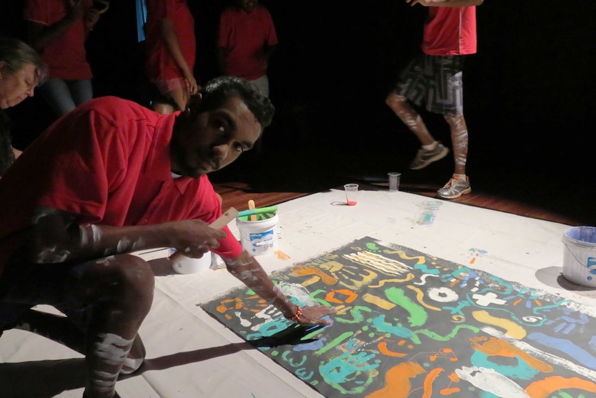 Russell Mick from Woorabinda puts his mark on the canvas to support Indigenous constitutional recognition.