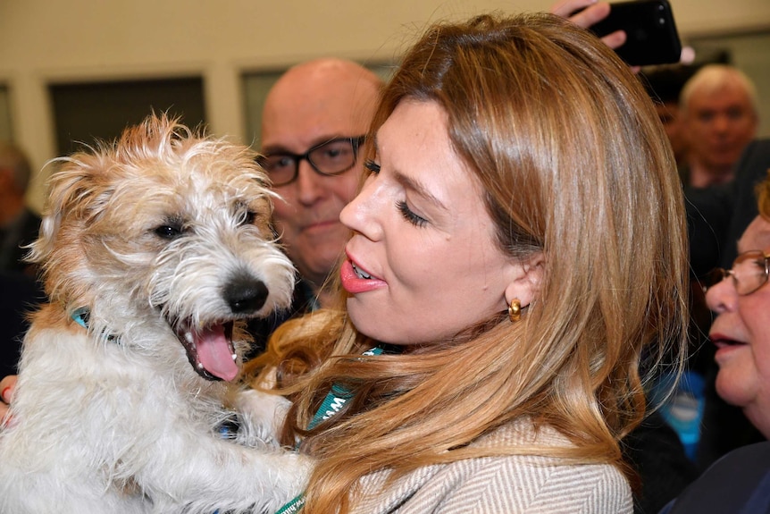 Carrie Symonds holding her jack russell
