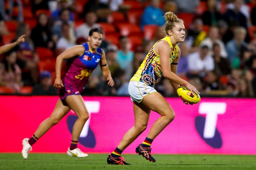 Zoe Prowse holds the ball out while looking for an option to pass to