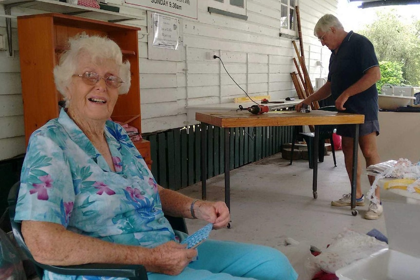 Douglas resident Jo Dau sits on a chair in the foreground while Brian Robers