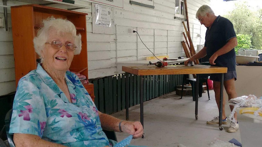 Douglas resident Jo Dau sits on a chair in the foreground while Brian Robers