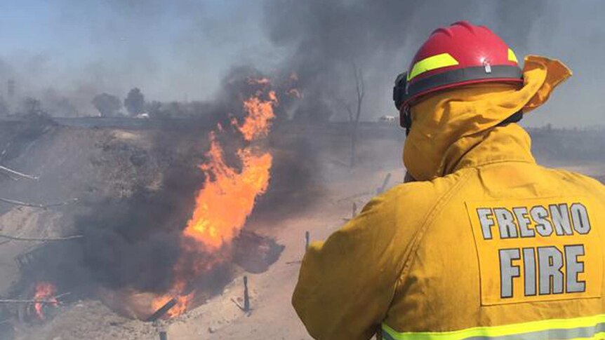 Firefighter watches blaze after gas explosion in California
