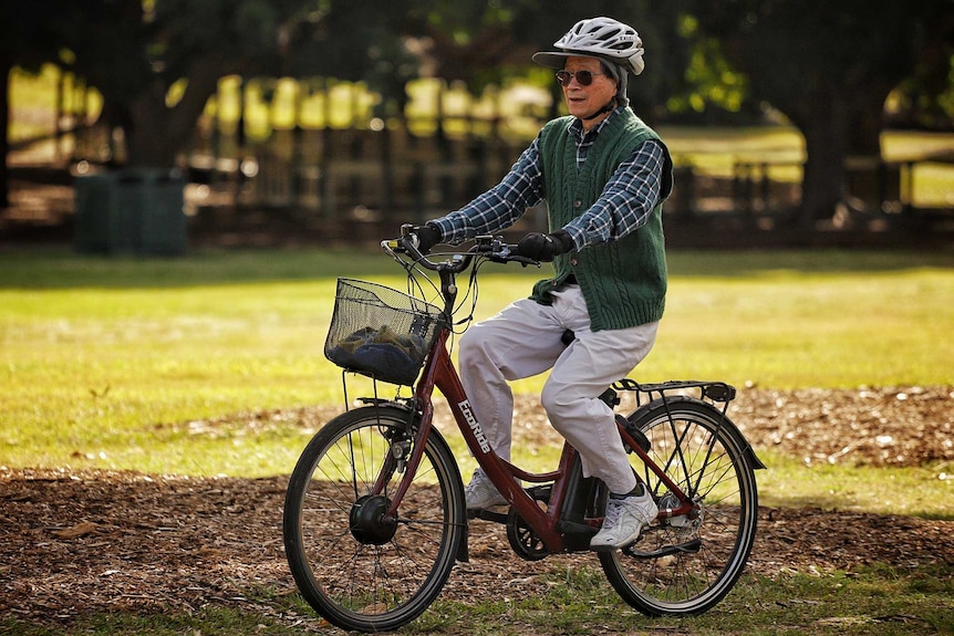 A man rides a push bike.