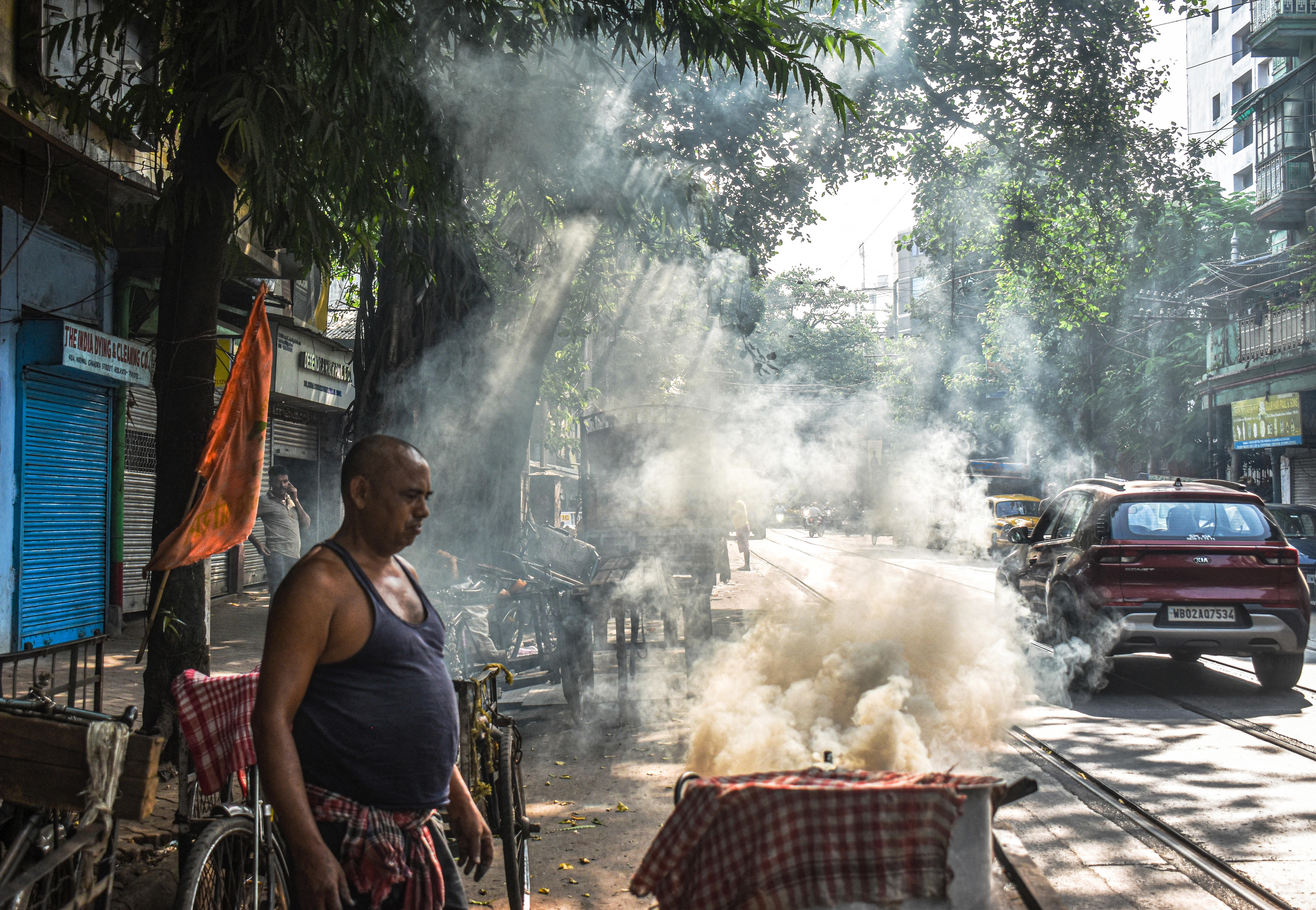 A roadside food vendor burns coal in Kolkata