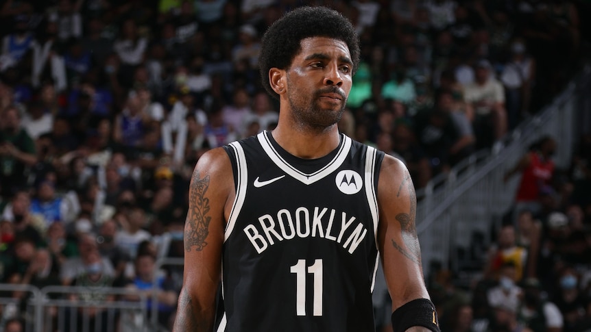 A Brooklyn Nets NBA player walks on the court during a game.