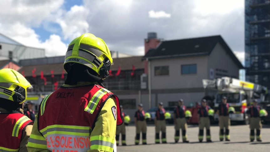 A group of firefighters standing a semi-circle.