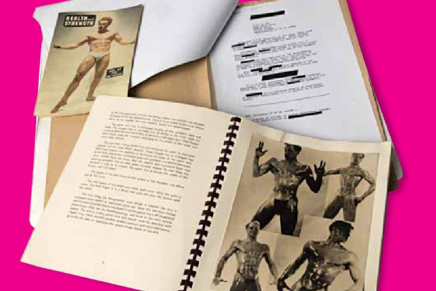Papers in a pile featuring censored photographs of naked men. 