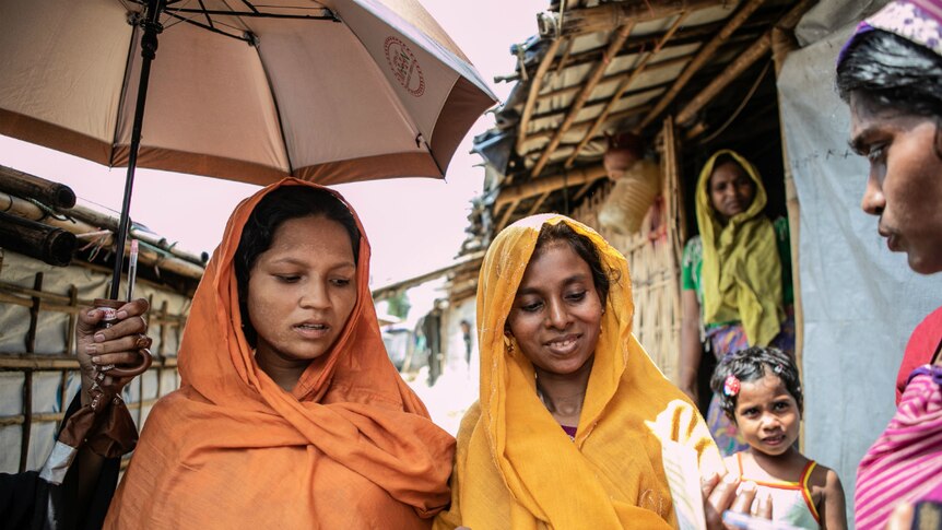 Jahanara and Dolu under an umbrella in Cox's Bazar.
