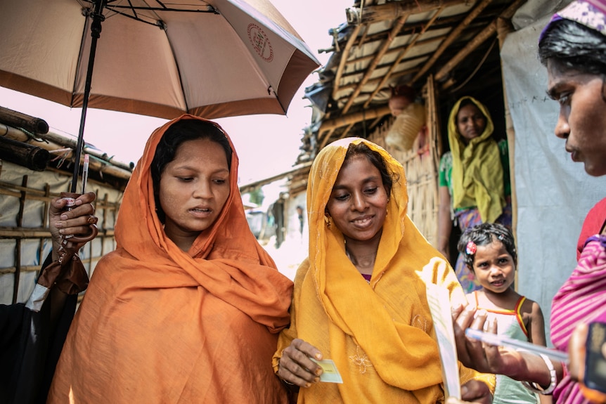 Jahanara and Dolu under an umbrella in Cox's Bazar.