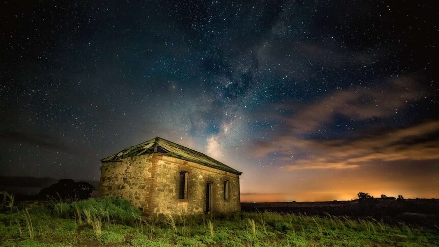Milky Way shines over little stone cottage
