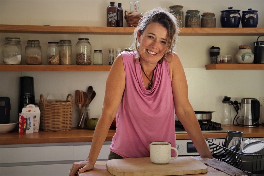 Emma Hohnen leans on a kitchen bench top.